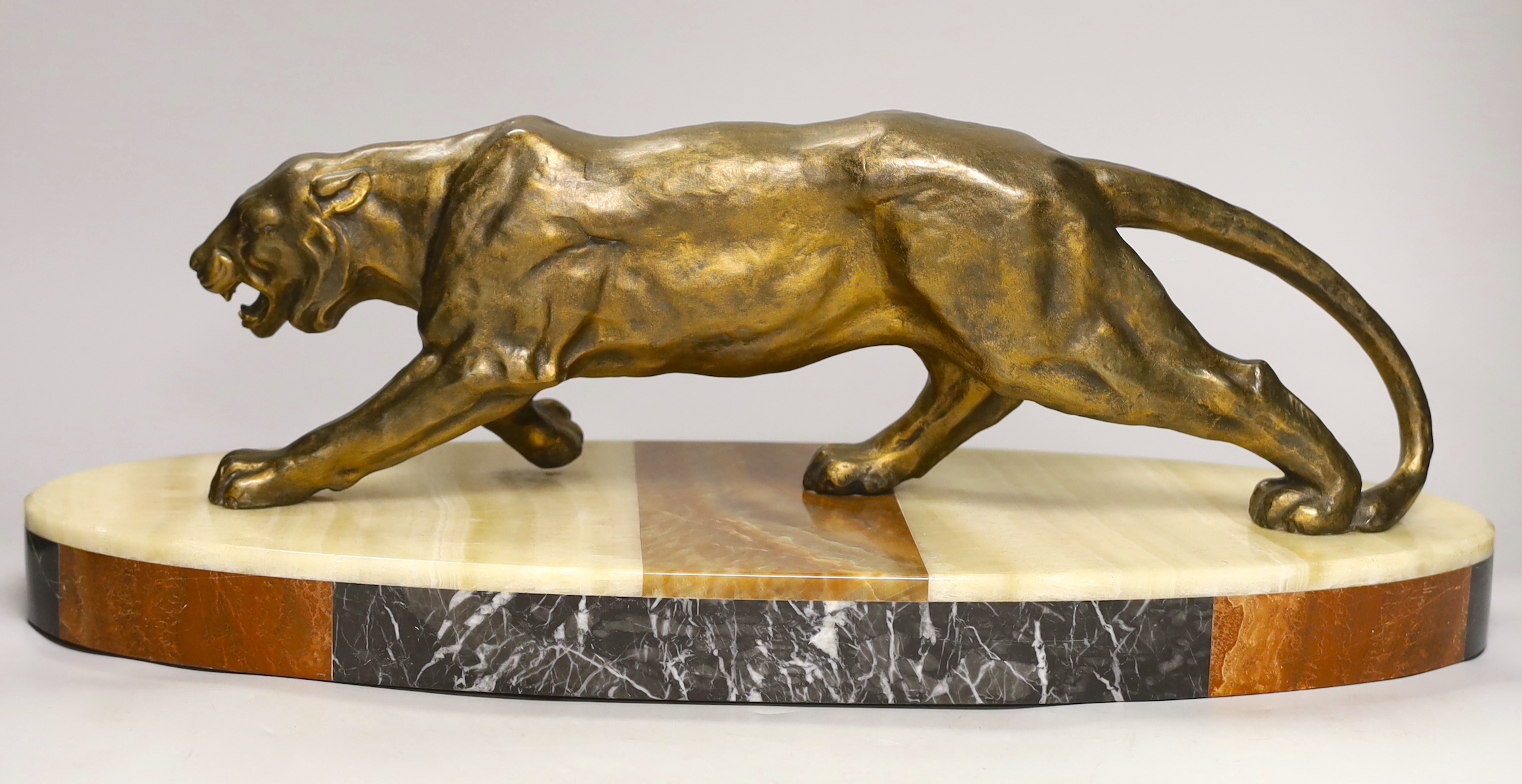 A French Art Deco model of a tiger, on marble base, 56cm long